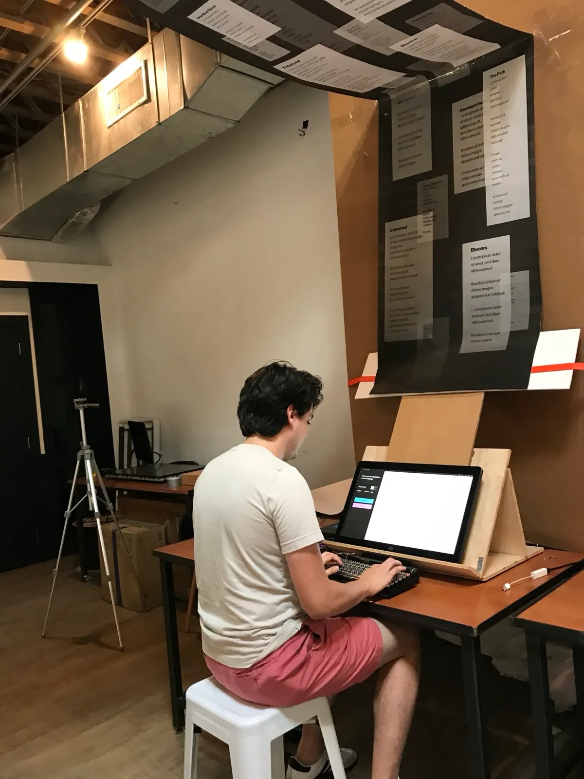 A tester writing with the prototype in the studio.